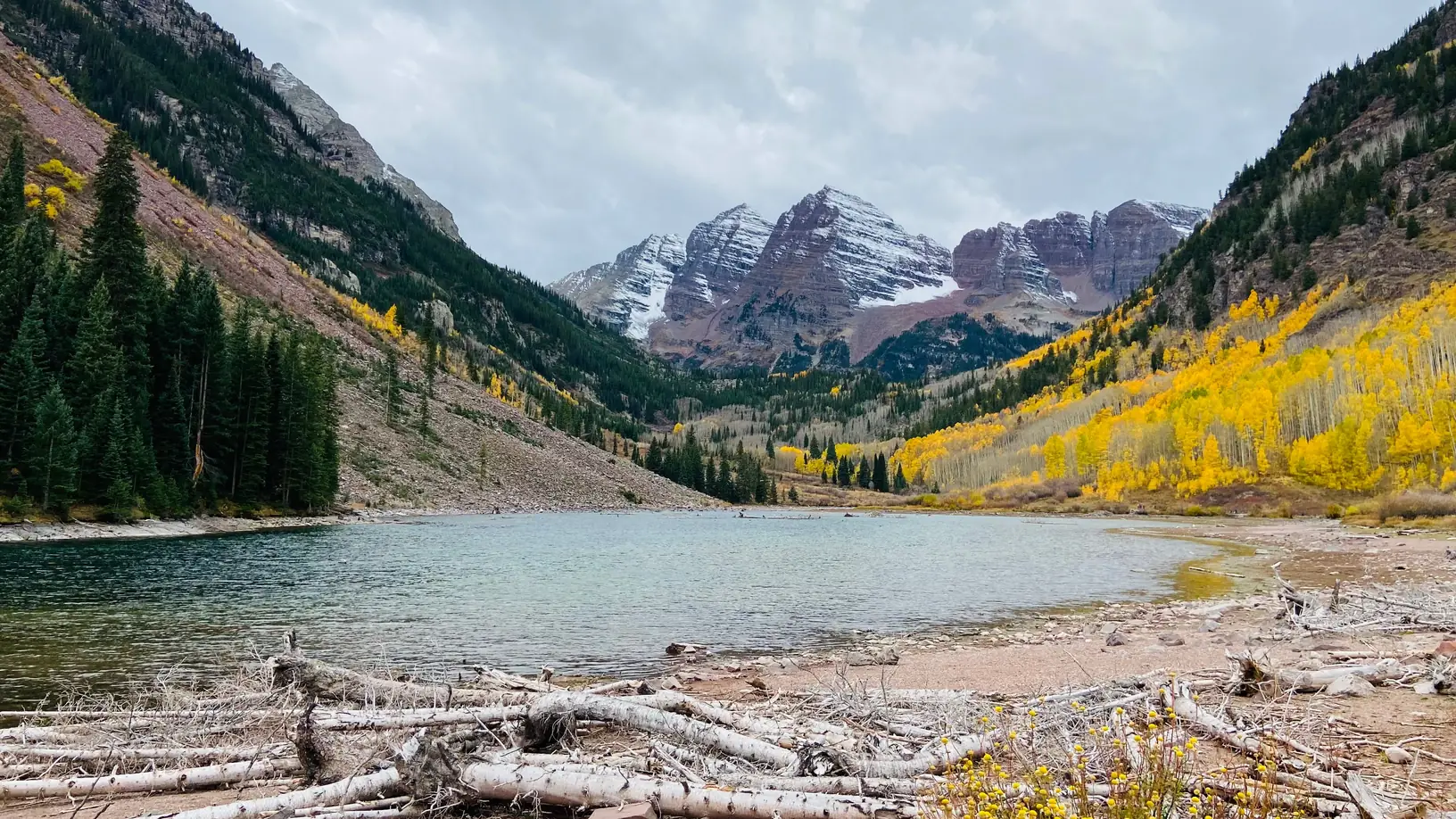Maroon Lake and the Maroon Bells framed by golden aspens near Aspen, Colorado